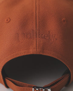 unlikely team cap オレンジ 値札タグなし　バッジあり Unlikely UNLIKELY TEAM CAP – NCNR ONLINE STORE