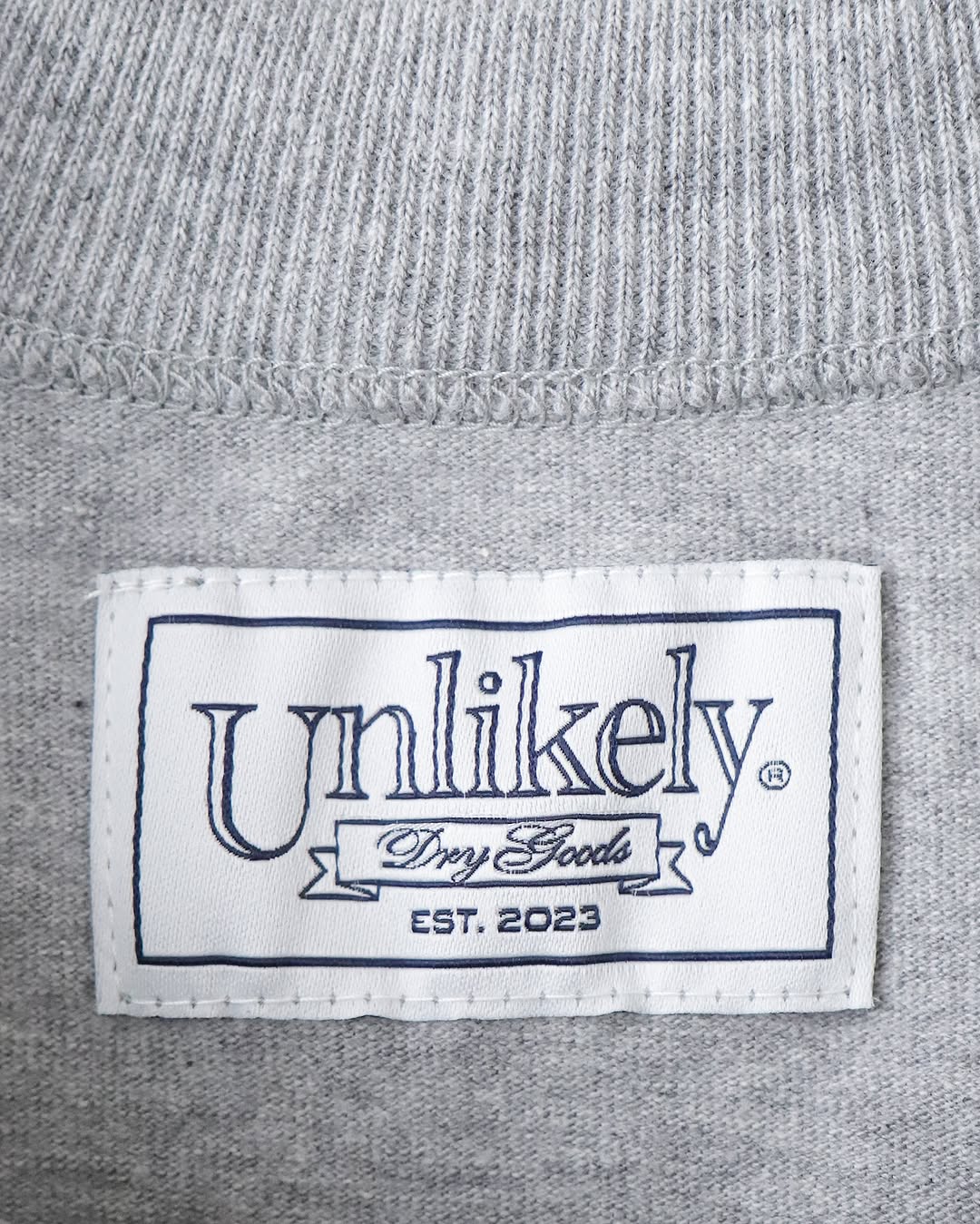 UNLIKELY TEAM TEE