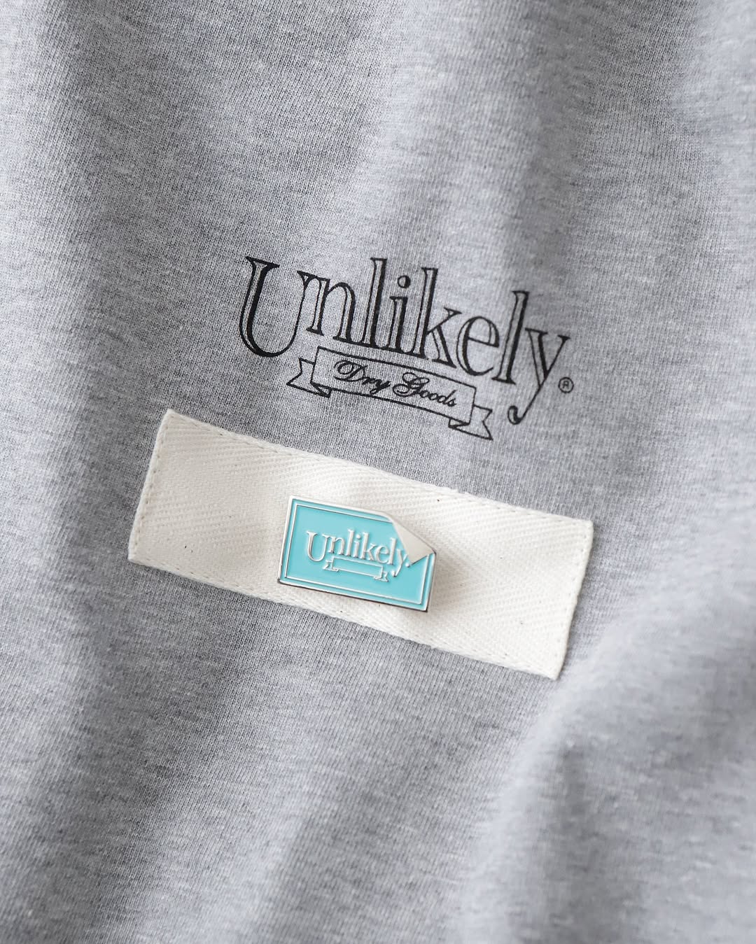 UNLIKELY TEAM TEE